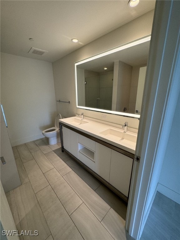 2000 Metropica Way Unit 1704, Sunrise, FL 33326 - full bath featuring a stall shower, toilet, double vanity, recessed lighting, and baseboards