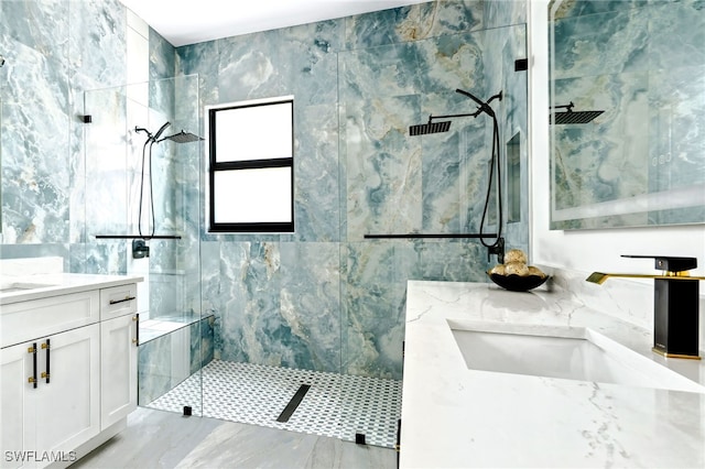 bathroom featuring tile walls, tiled shower, and vanity