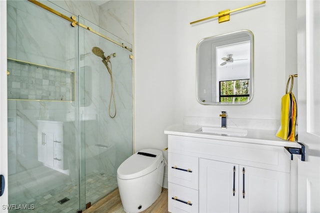 bathroom featuring an enclosed shower, vanity, toilet, and hardwood / wood-style floors