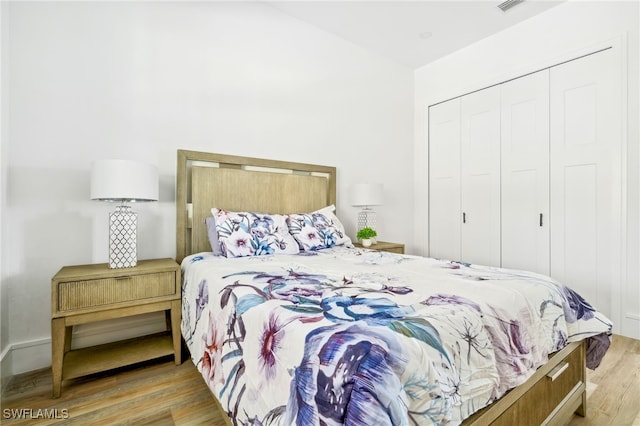 bedroom with a closet and light hardwood / wood-style flooring