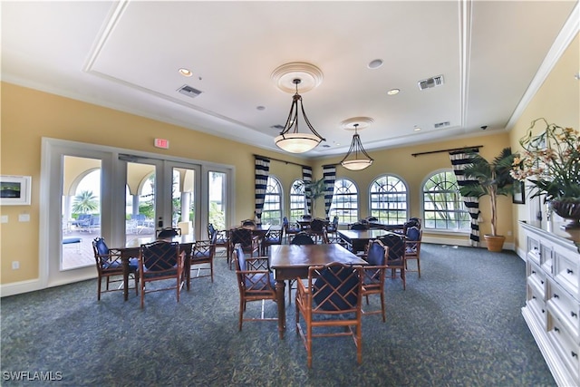 dining room with french doors, crown molding, and dark carpet