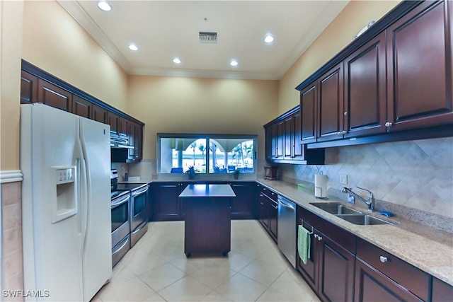 kitchen featuring sink, appliances with stainless steel finishes, ornamental molding, a kitchen island, and decorative backsplash