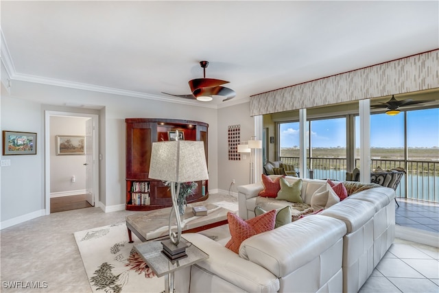 tiled living room featuring a water view, ceiling fan, and crown molding