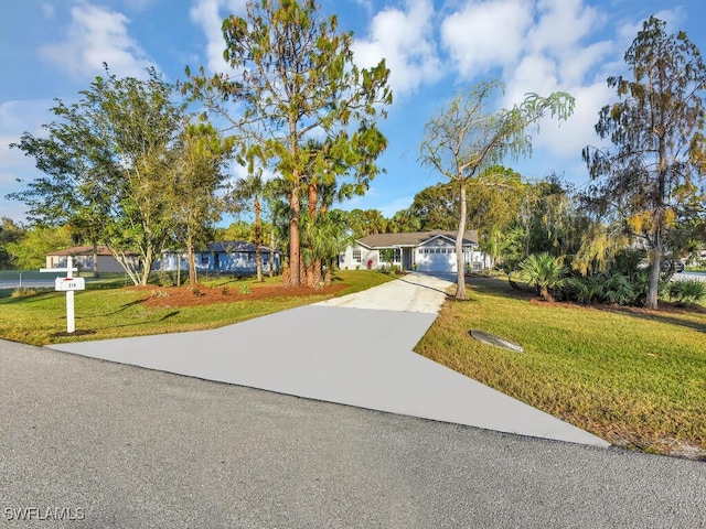 view of front of property featuring a garage and a front yard