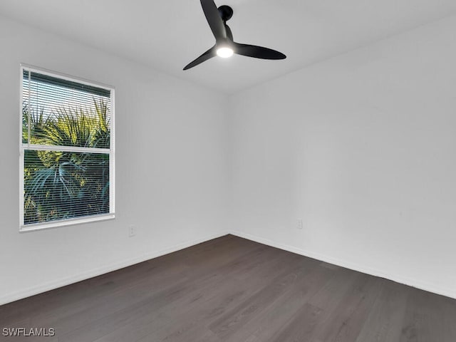 spare room featuring dark hardwood / wood-style floors and ceiling fan