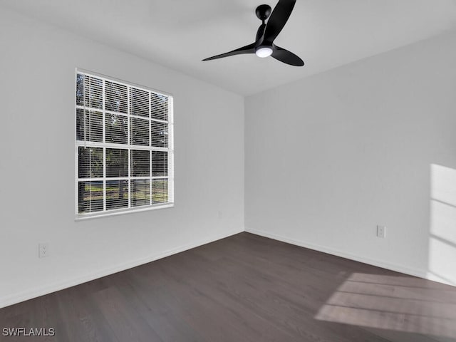 unfurnished room with ceiling fan and dark wood-type flooring