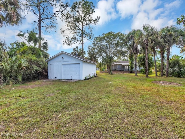 view of yard with a garage and an outdoor structure