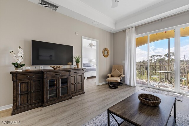 living room with light hardwood / wood-style flooring and ceiling fan