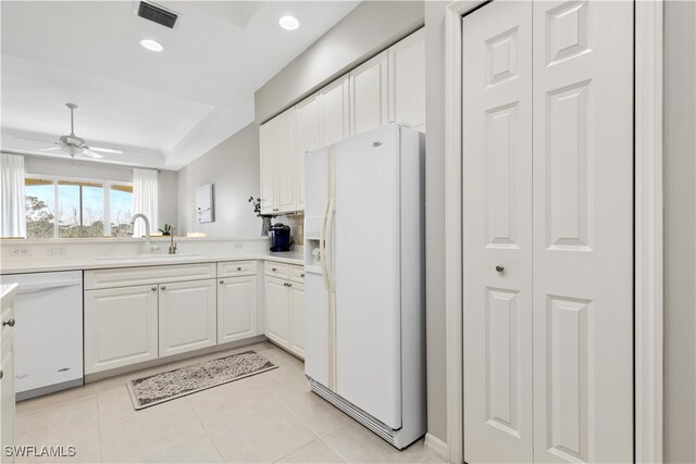 kitchen with light tile patterned flooring, sink, white cabinets, white appliances, and ceiling fan