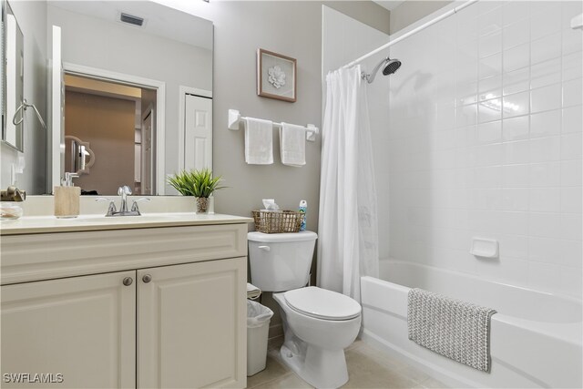 full bathroom featuring vanity, tile patterned flooring, shower / bathtub combination with curtain, and toilet