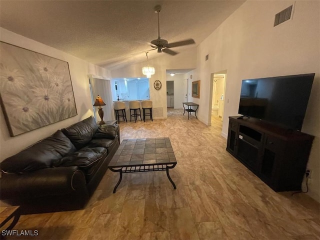 living room featuring a textured ceiling, high vaulted ceiling, light hardwood / wood-style floors, and ceiling fan