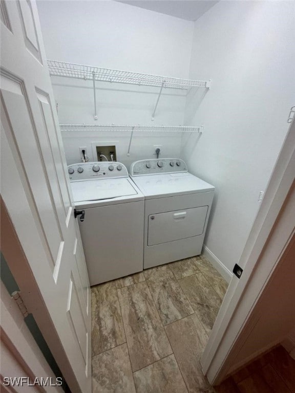 clothes washing area with washing machine and clothes dryer