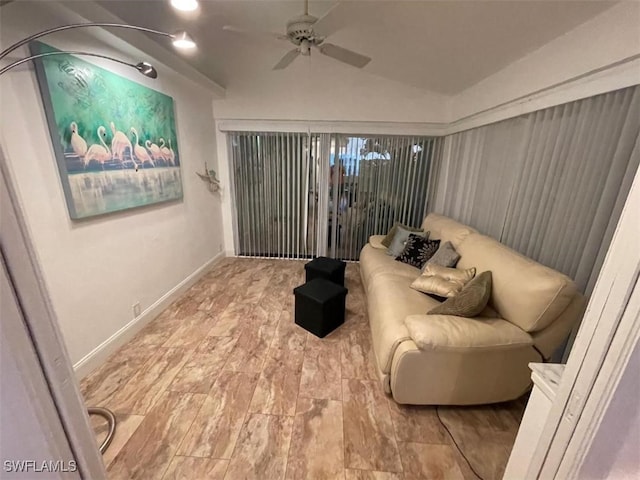 living area featuring lofted ceiling and ceiling fan