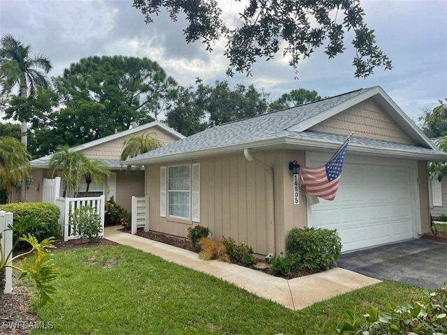 view of front facade with a garage and a front yard