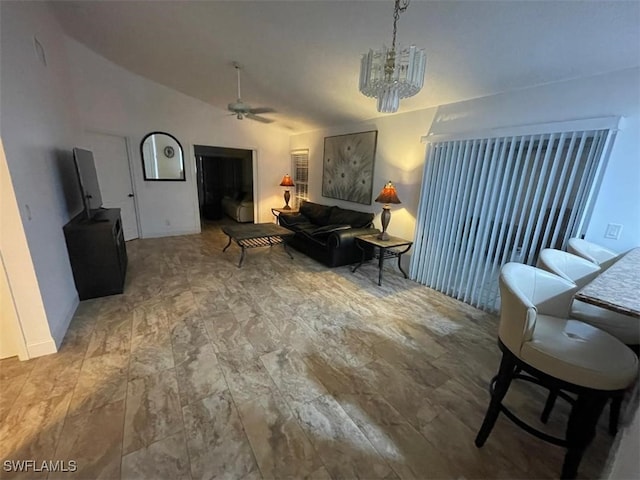 living room featuring lofted ceiling and ceiling fan with notable chandelier