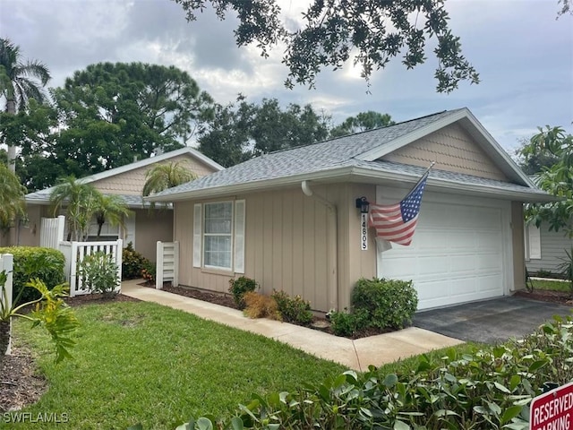 view of front of house featuring a garage and a front lawn