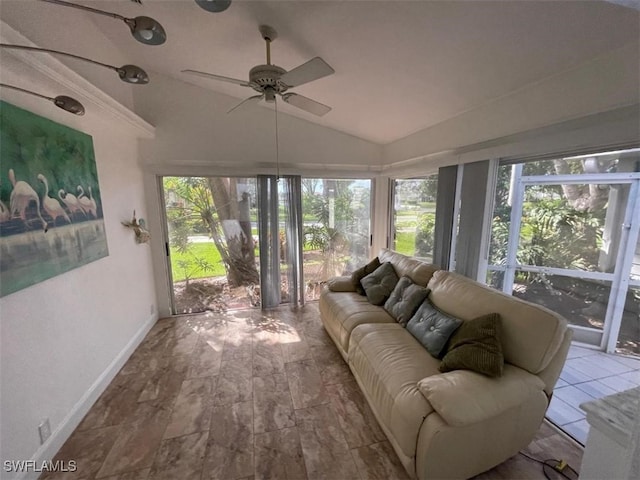 sunroom / solarium with ceiling fan, a healthy amount of sunlight, and lofted ceiling