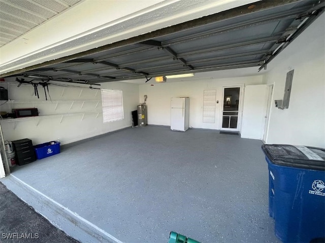 garage featuring electric water heater, electric panel, white refrigerator, and a garage door opener