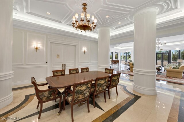 dining space with ornate columns, a wealth of natural light, a chandelier, and ornamental molding