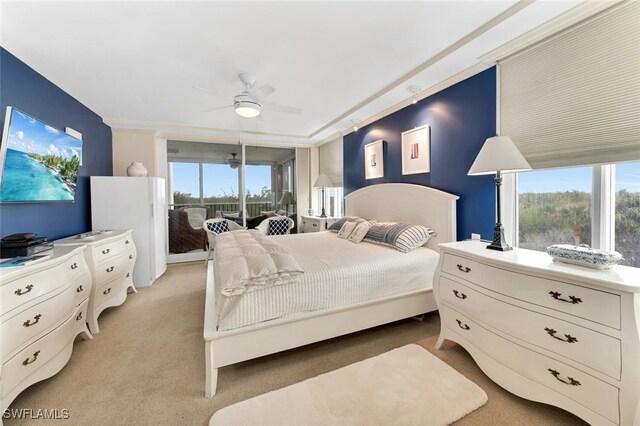 carpeted bedroom featuring access to exterior and ceiling fan