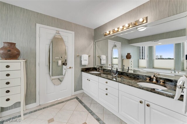 bathroom featuring a washtub and vanity