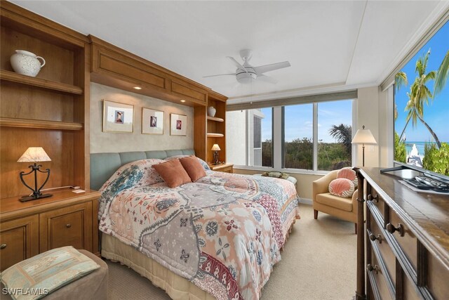 bedroom with ceiling fan and light carpet