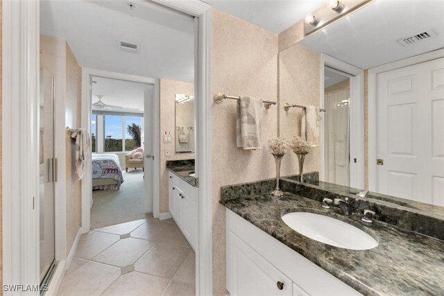 bathroom featuring tile patterned flooring, vanity, and an enclosed shower