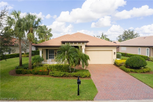 mediterranean / spanish-style home featuring a garage and a front lawn