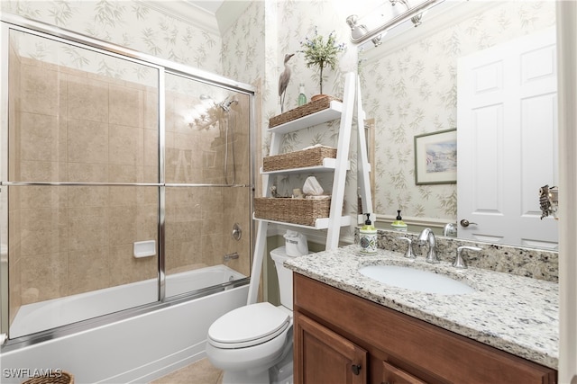 full bathroom with ornamental molding, vanity, combined bath / shower with glass door, and toilet