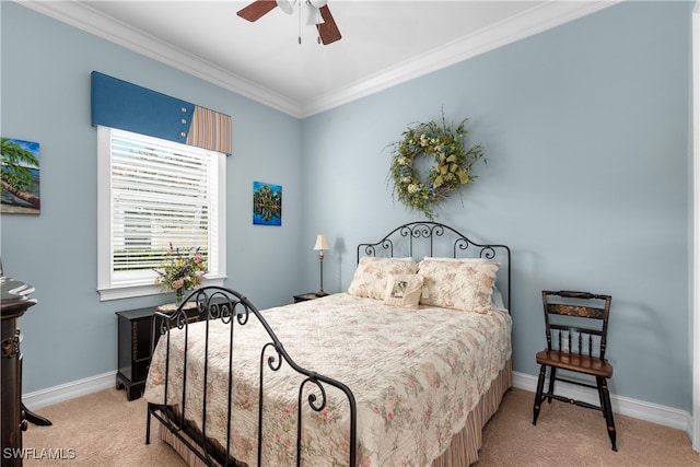 bedroom featuring ornamental molding, light colored carpet, and ceiling fan