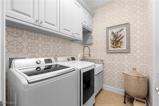 laundry area with cabinets, light tile patterned flooring, crown molding, and independent washer and dryer