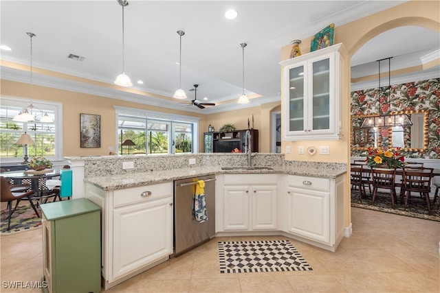 kitchen with white cabinets, hanging light fixtures, stainless steel dishwasher, ceiling fan, and a tray ceiling