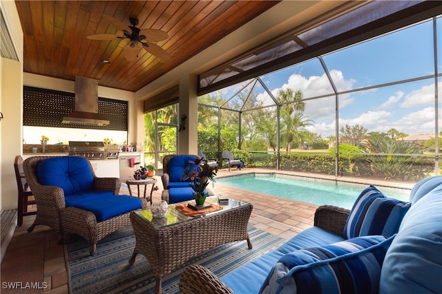 view of patio featuring an outdoor living space, grilling area, glass enclosure, and ceiling fan