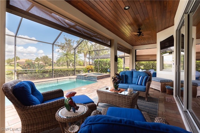 exterior space with glass enclosure, a pool with hot tub, ceiling fan, and an outdoor living space