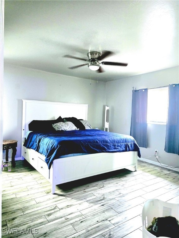 bedroom with ceiling fan and light hardwood / wood-style floors