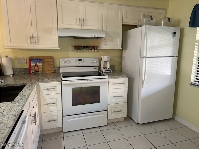 kitchen featuring sink, light tile patterned floors, light stone counters, white appliances, and white cabinets