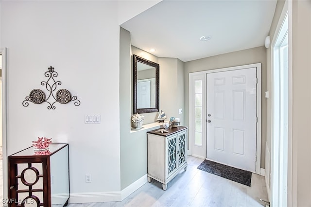 foyer with light hardwood / wood-style flooring and a healthy amount of sunlight