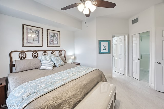 bedroom with a closet, ceiling fan, and light hardwood / wood-style flooring