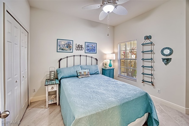 bedroom with light hardwood / wood-style floors, ceiling fan, and a closet