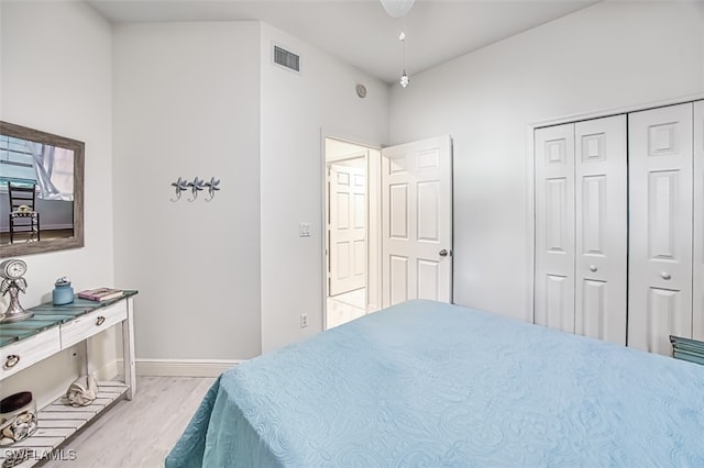 bedroom with a closet and light hardwood / wood-style floors