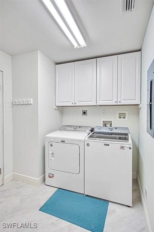 washroom featuring washer and clothes dryer and cabinets