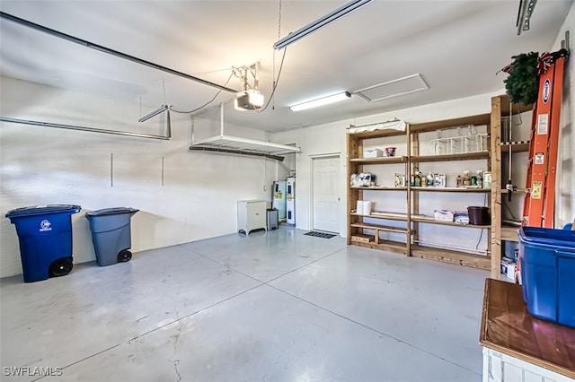 garage with electric water heater and a garage door opener