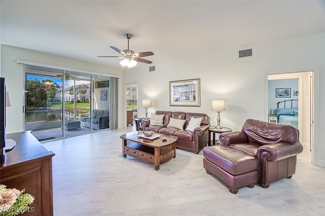 living room with light hardwood / wood-style floors and ceiling fan