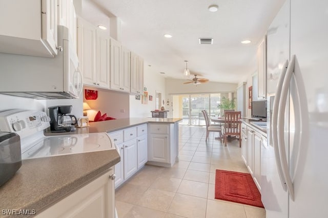 kitchen featuring white cabinetry, white refrigerator with ice dispenser, kitchen peninsula, vaulted ceiling, and light tile patterned floors