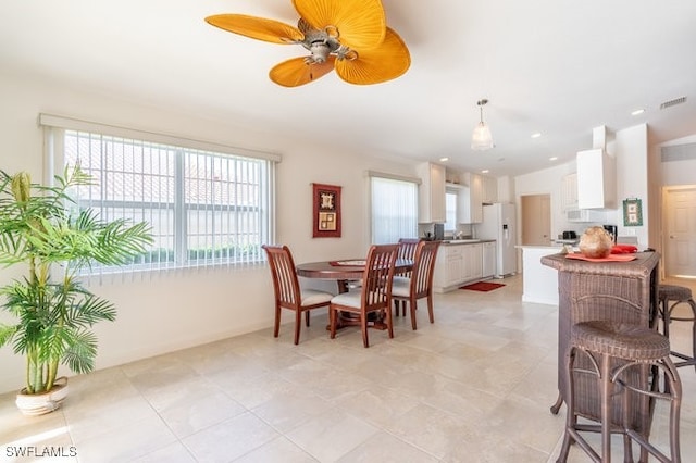 dining room featuring ceiling fan and light tile patterned flooring