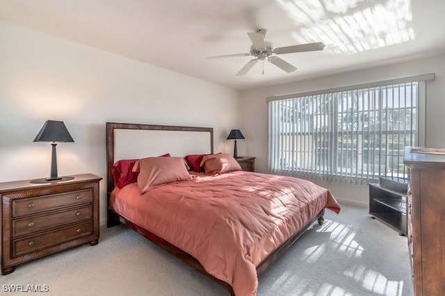 bedroom with light colored carpet and ceiling fan