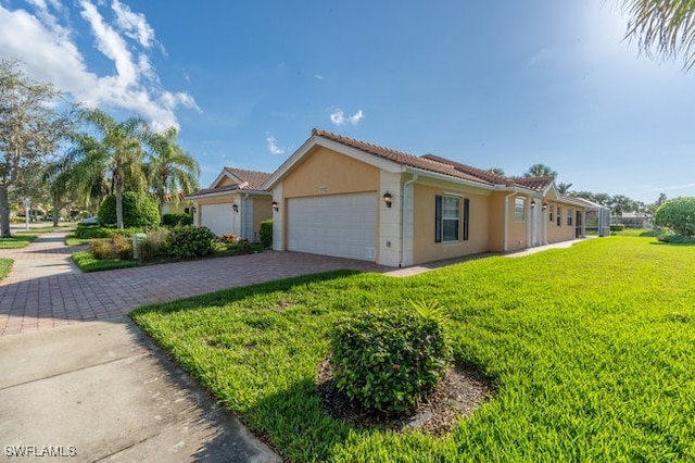 view of front of property with a front lawn and a garage