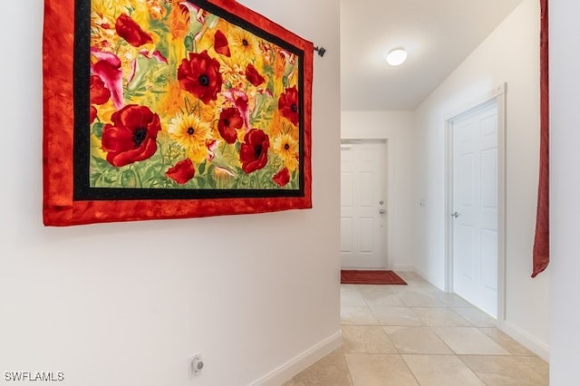 hall with tile patterned flooring and lofted ceiling