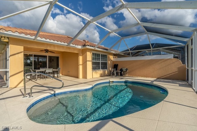 view of pool featuring a lanai, a patio area, and ceiling fan