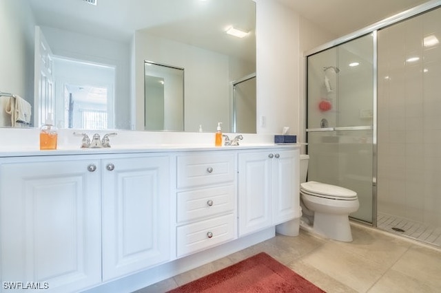 bathroom featuring toilet, tile patterned flooring, vanity, and walk in shower